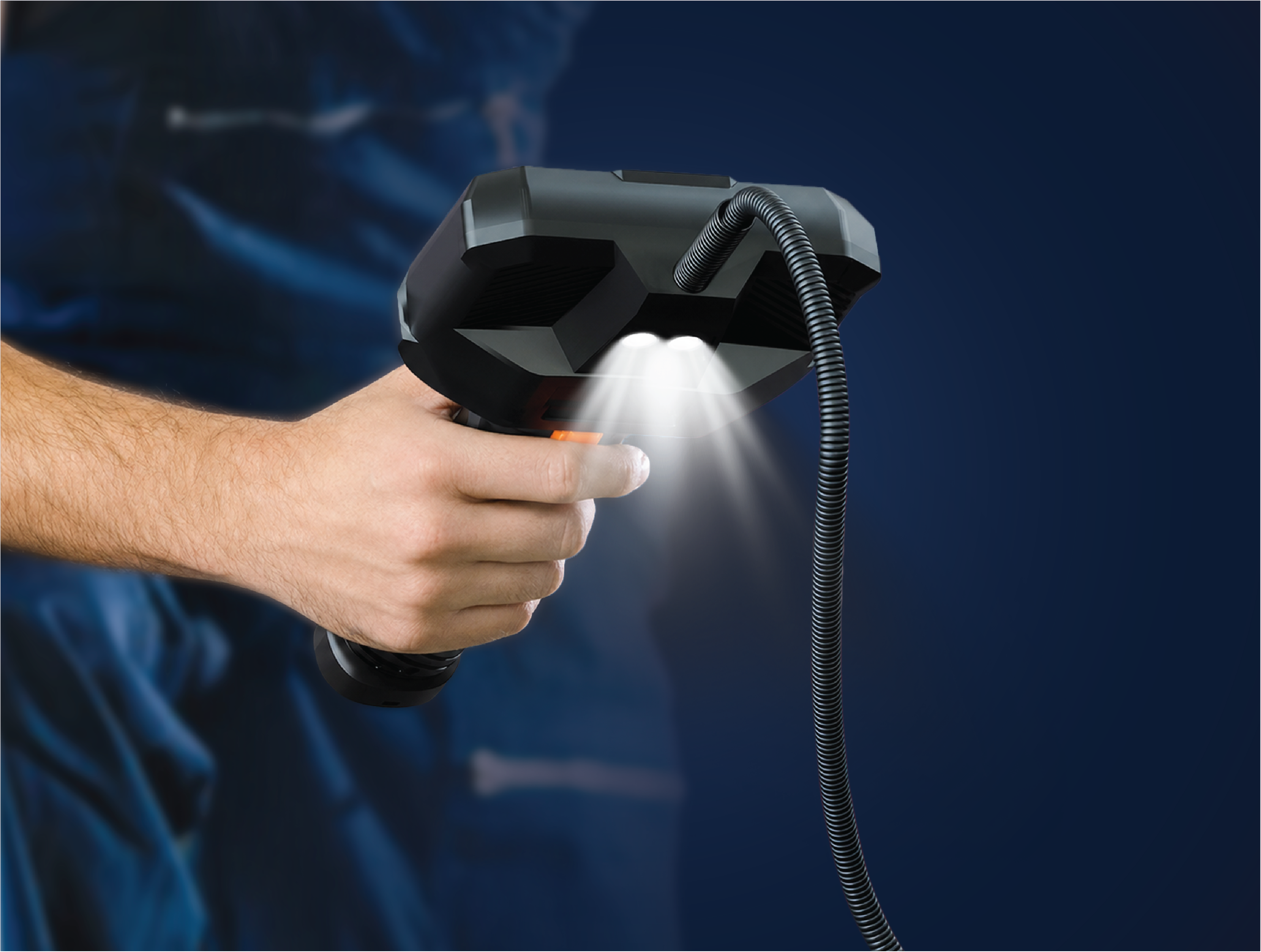 Hand holding RS2 with body-mounted work lights on
